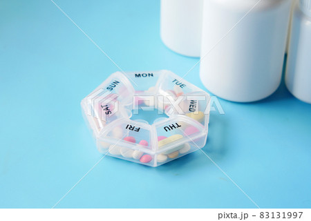 pill box and medical pill container on blue pill box and medical pill container on blue 83131997