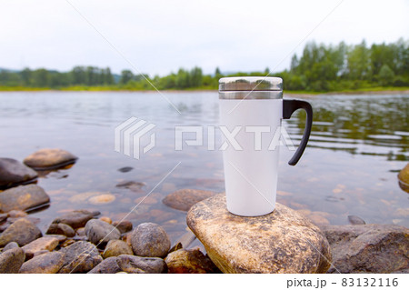 White travel mug mockup with river view 83132116