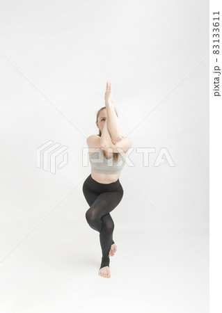 Young woman doing yoga asana Garudasana Eagle Pose isolated on white  background Stock Photo - Alamy