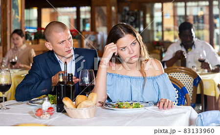 Young couple man and woman quarreling in restaurant 83133960