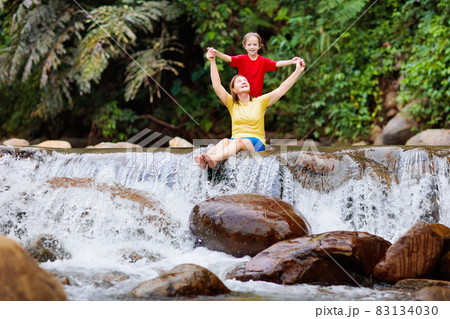 Family with child at waterfall. Travel with kids. Family with child at waterfall. Travel with kids. 83134030