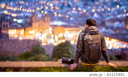Asian man traveler looking at Cusco city at night 83135891