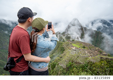 Asian couple tourist taking photo of Machu Picchu 83135899