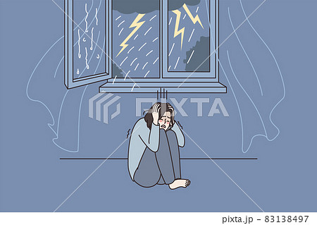 Anxious woman feel scared of thunderstorm at home  83138497