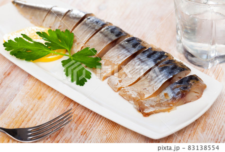 Smoked mackerel fillets with lemon and greens 83138554