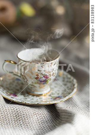Porcelain tea pot and cup of hot tea on the table, antique traditional crockery set, high tea English afternoon tea Porcelain tea pot and cup of hot tea on the table, antique traditional crockery set, high tea English afternoon tea 83138983