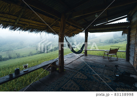 In a wooden hut in a green rice field 83138998