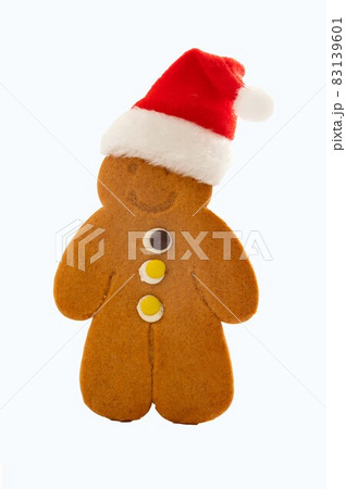 Gingerbread man cookie with Christmas red hat, isolated on white 83139601