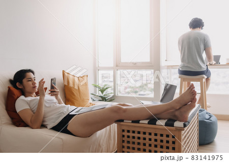 Couple living work and rest in the same room apartment. 83141975