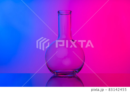 Chemical glassware close up on neon pink-purple background 83142455