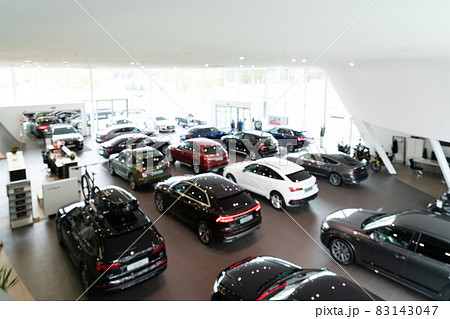 Blurred background of new cars displayed in luxury showroom, panorama Blurred background of new cars displayed in luxury showroom, panorama 83143047