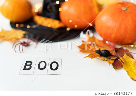 Boo inscription isolated on white background. Against the background of a spider, a mouse, a hat, yellow leaves. Holiday and party concept. 83143177