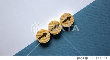 Business concept growth success process. Wood circles stacking as step stair on paper white and blue background, copy space. Business concept growth success process. Wood circles stacking as step stair on paper white and blue background, copy space. 83144861