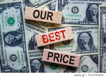 Concept text 'our best price' on wooden blocks on a beautiful background from dollar bills. Concept text 'our best price' on wooden blocks on a beautiful background from dollar bills. 83144869