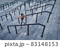 Top view of young athletic woman running upstairs fast, training at urban city stadium 83148153