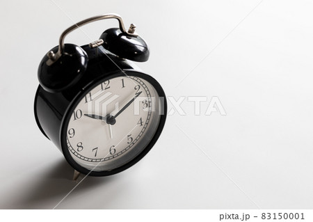 Black and white vintage classic alarm clock at ten o'clock with white space. Black and white vintage classic alarm clock at ten o'clock with white space. 83150001