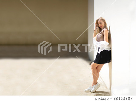 Portrait of young beautiful woman blonde hair standing against wall with copy space 83153307