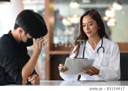 Beautiful female doctor giving advice and explaining treatment to her patient. 83154617