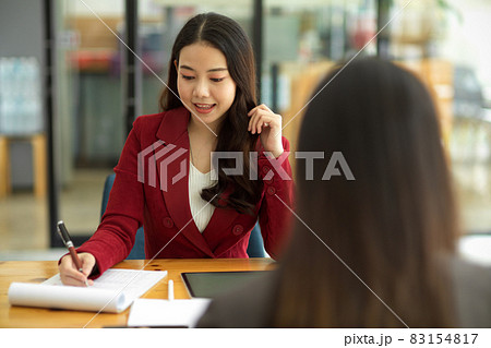 Two beautiful businesswomen discuss a new project, consult on business issues Two beautiful businesswomen discuss a new project, consult on business issues 83154817