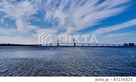 Cable-stayed bridge across the Neva River against the blue sea and sky with clouds 83156823