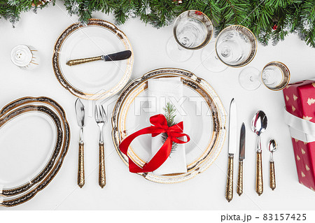 Christmas table setting with pine tree branches and decorations top view Christmas table setting with pine tree branches and decorations top view 83157425