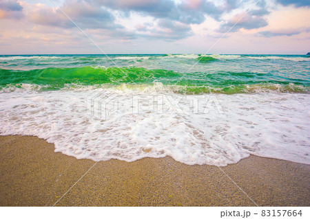 evening landscape at the sea. beautiful nature scenery. summer vacation concept. dramatic sky above the horizon. waves run on sandy beach evening landscape at the sea. beautiful nature scenery. summer vacation concept. dramatic sky above the horizon. waves run on sandy beach 83157664