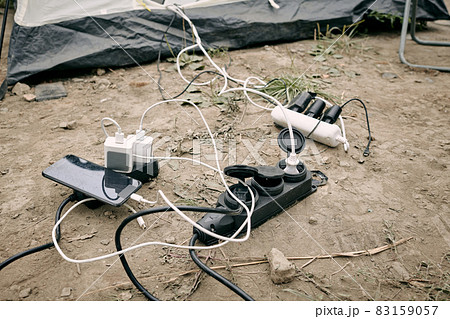 Smartphone and powerbanks charging on the ground 83159057