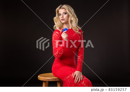 Young emotional woman holding a bunch of chips in her hands. Poker Young emotional woman holding a bunch of chips in her hands. Poker 83159257