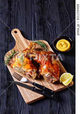 roasted pork shanks on a wood board, top view 83159466