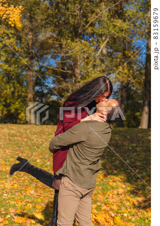 Lovely couple having fun together in nature. Boyfriend carrying his girlfriend in his arms. Lovely couple having fun together in nature. Boyfriend carrying his girlfriend in his arms. 83159679