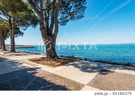 Lakeshore of Lake Garda in Lazise village - Verona Veneto Italy 83160379