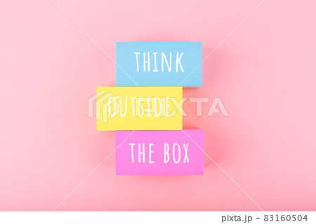 Creativity concept. Think outside the box written on colorful rectangles on bright pink background Creativity concept. Think outside the box written on colorful rectangles on bright pink background 83160504
