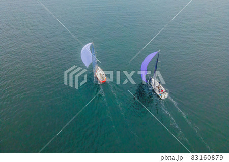 Aerial bird's eye view photo taken by drone of sailboat in turquoise sea water 83160879