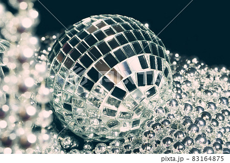 Mirror balls reflecting lights close up, nightlife background Mirror balls reflecting lights close up, nightlife background 83164875