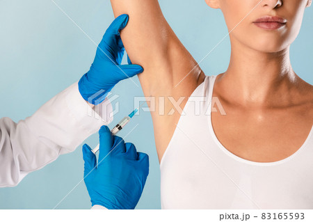 Woman having hyperhidrosis treatment at beauty salon 83165593