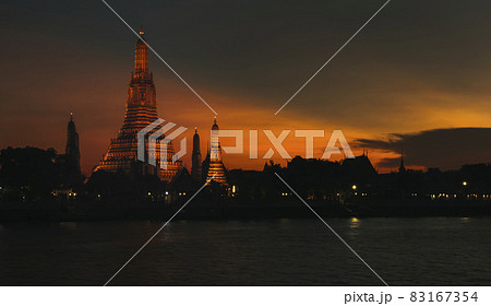View of beautiful Wat Arun Rajvararam or Wat Arun or Wat Makok at waterfront of the Chao Phraya River in twilight,Which is historical significance and famous tourist destination of Bangkok,Thailand. 83167354