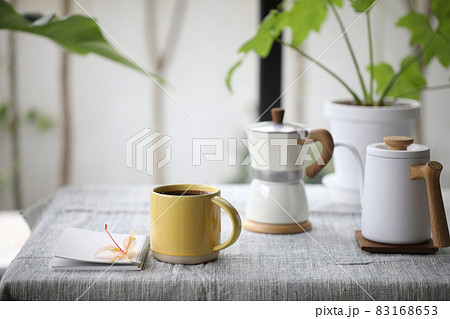 Yellow coffee cup and coffee brew pot and flower  83168653