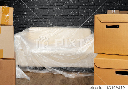 Moving in or moving out concept. Stack of boxes and packed furniture 83169859