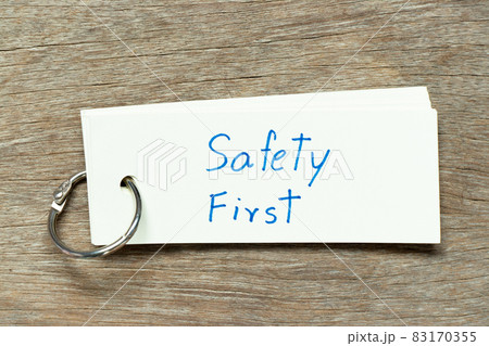 Flash card with handwriting word safety first on wood background Flash card with handwriting word safety first on wood background 83170355