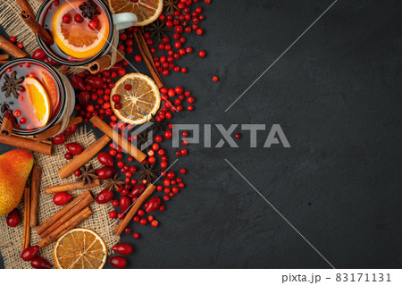 Top view of hot mulled wine and spices on black background Top view of hot mulled wine and spices on black background 83171131