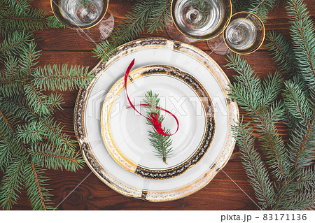 Christmas table setting with pine tree branches and decorations top view 83171136