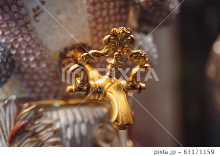 closeup of gold plated spigot of glass samovar closeup of gold plated spigot of glass samovar 83171159