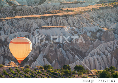 white hot air balloon with rising over the Cappadocian valley white hot air balloon with rising over the Cappadocian valley 83171163