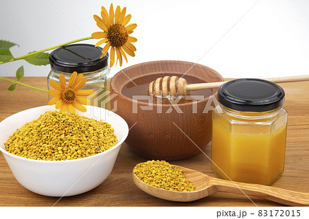 Fresh flower honey in a wooden bowl, spoon, pollen. vitamin food for health and life Fresh flower honey in a wooden bowl, spoon, pollen. vitamin food for health and life 83172015