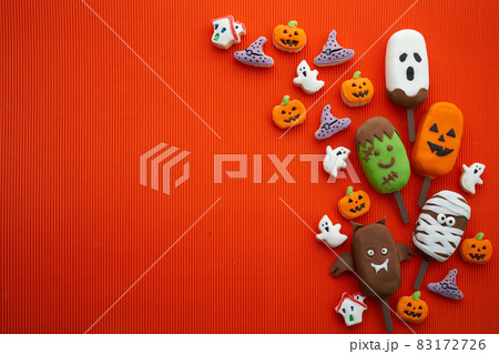 Set of ice cream and cookies with halloween character face on orange background. Halloween party background Set of ice cream and cookies with halloween character face on orange background. Halloween party background 83172726