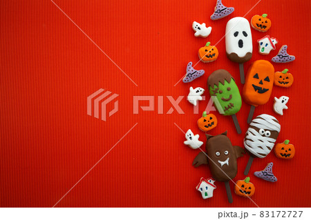 Set of ice cream and cookies with halloween character face on orange background. Halloween party background 83172727