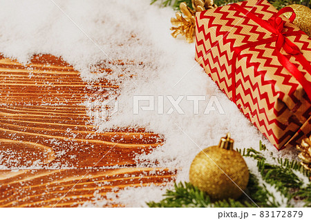 Craft gift boxes over snowy wooden table close up 83172879