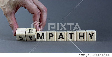 Sympathy or empathy symbol. Businessman turns wooden cubes and changes the word 'empathy' to 'sympathy'. Beautiful grey background. Copy space. Psychological, sympathy or empathy concept. 83173211