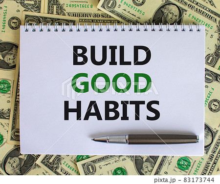 Build good habits symbol. Words 'Build good habits' on white note. Beautiful background from dollar bills, metallic pen. Business, psychology and build good habits concept. Copy space. 83173744