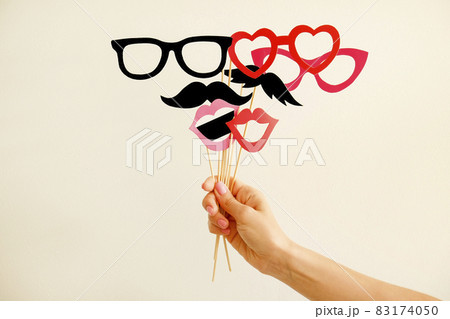 Paper party attributes in form of moustache on wooden stick. Carnival accessory concept. 83174050